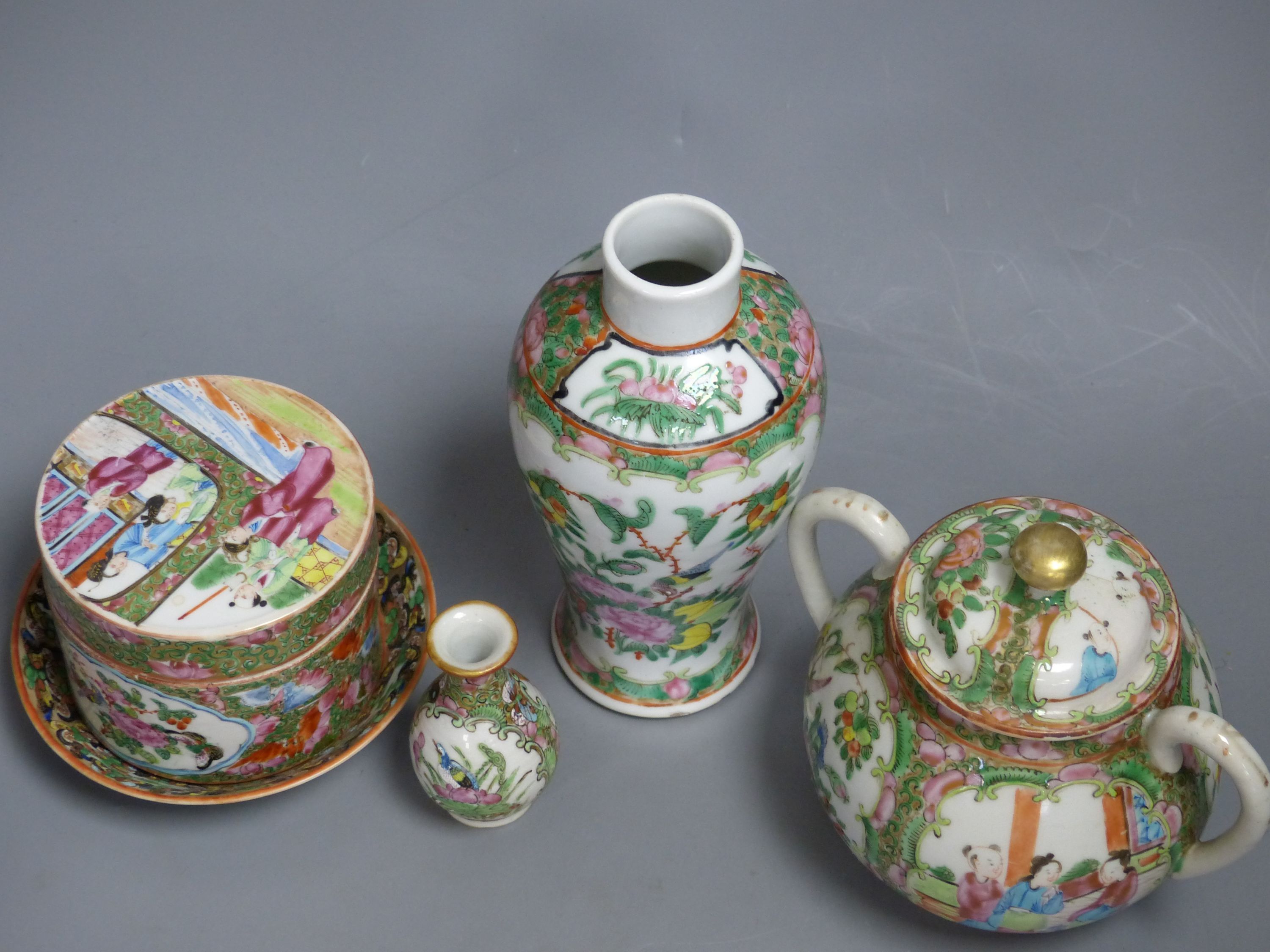 A Chinese famille rose box and cover, two vases, a sugar bowl and cover and a saucer, late 19th/early 20th century, tallest 19cm